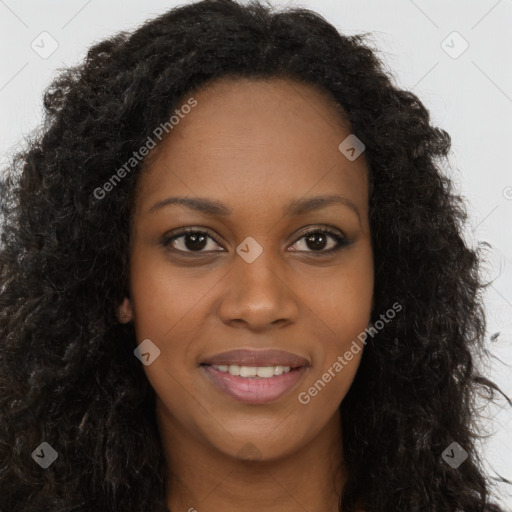 Joyful black young-adult female with long  brown hair and brown eyes