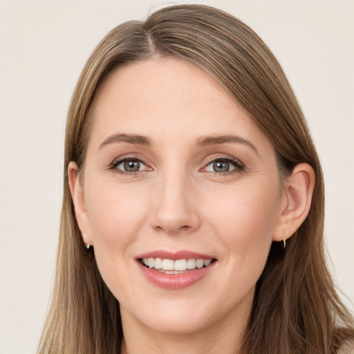 Joyful white young-adult female with long  brown hair and grey eyes