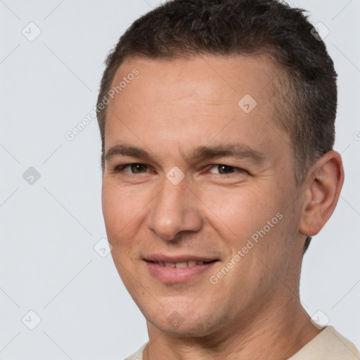 Joyful white adult male with short  brown hair and brown eyes