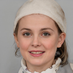 Joyful white young-adult female with medium  brown hair and blue eyes