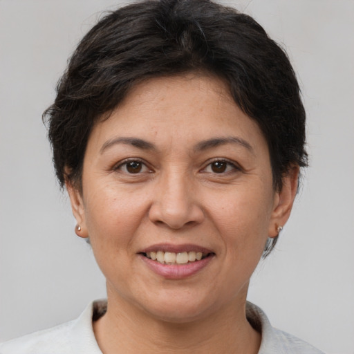 Joyful white adult female with short  brown hair and brown eyes