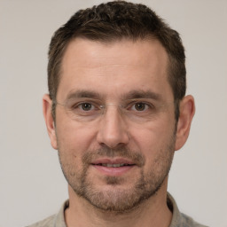 Joyful white adult male with short  brown hair and grey eyes