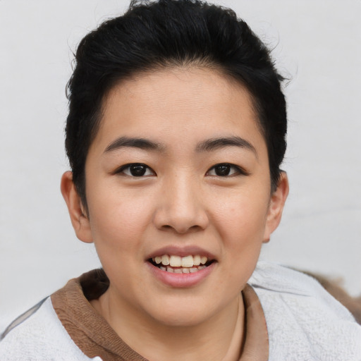 Joyful asian young-adult female with short  black hair and brown eyes