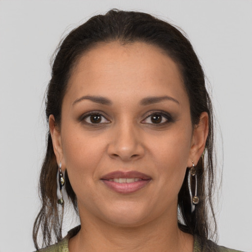 Joyful latino young-adult female with medium  brown hair and brown eyes