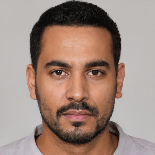 Neutral latino young-adult male with short  black hair and brown eyes