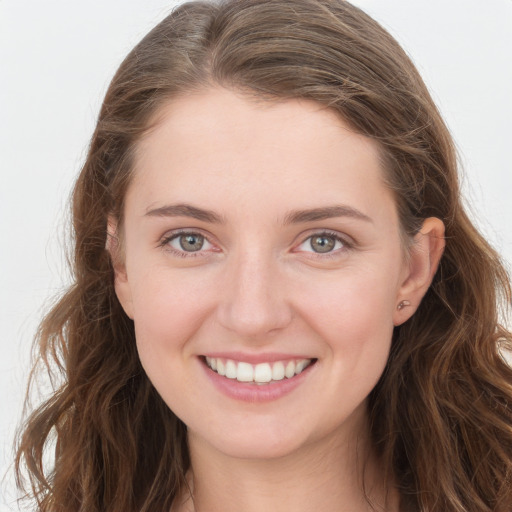 Joyful white young-adult female with long  brown hair and grey eyes