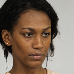 Neutral black young-adult female with medium  brown hair and brown eyes