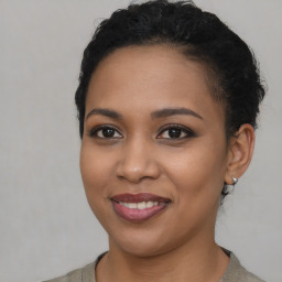 Joyful latino young-adult female with short  brown hair and brown eyes