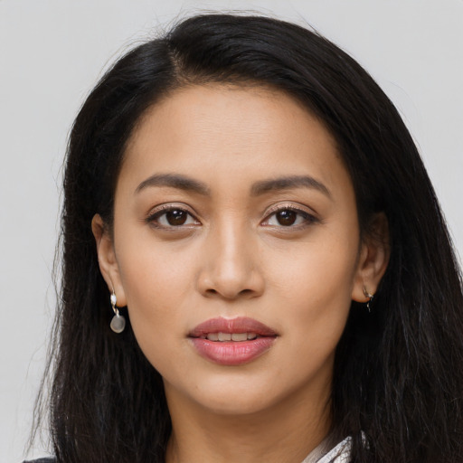 Joyful latino young-adult female with long  black hair and brown eyes