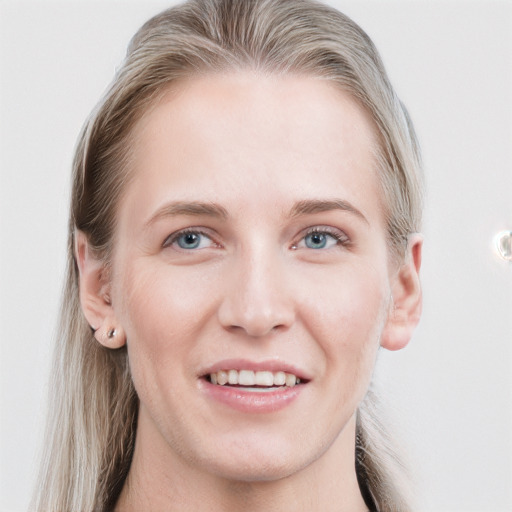 Joyful white young-adult female with long  brown hair and blue eyes