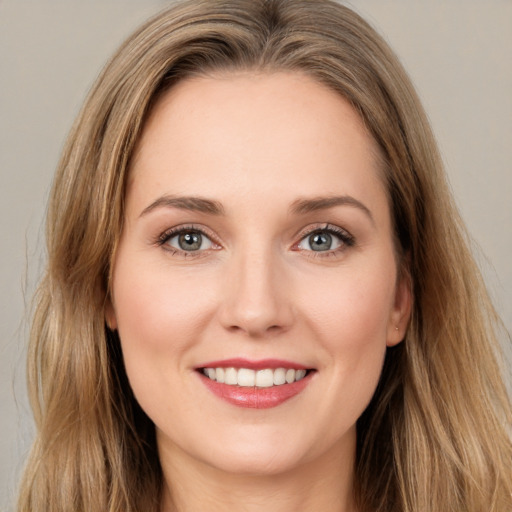 Joyful white young-adult female with long  brown hair and green eyes