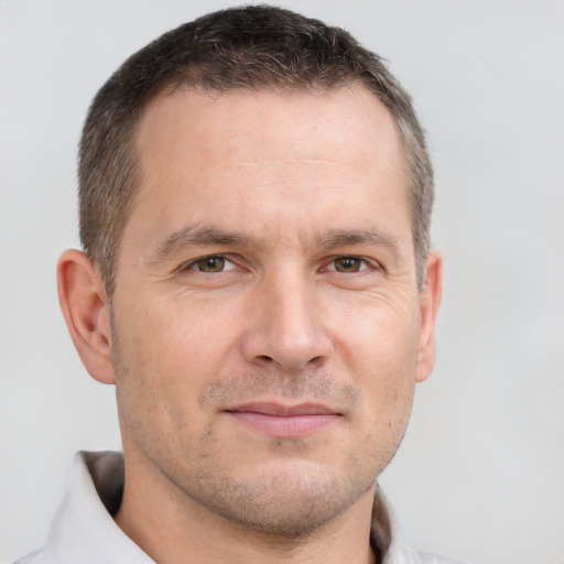 Joyful white adult male with short  brown hair and brown eyes