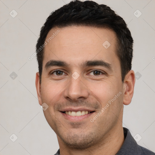 Joyful white young-adult male with short  black hair and brown eyes