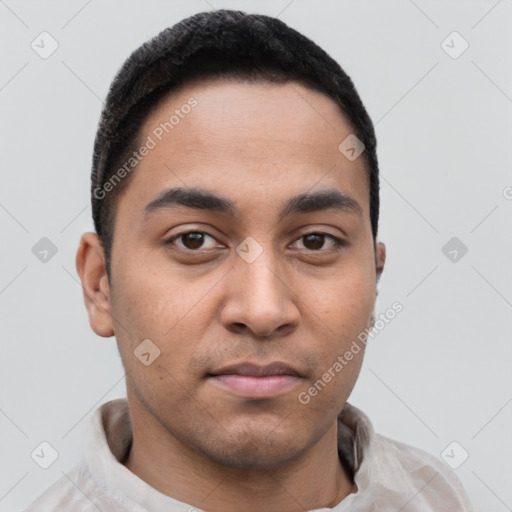 Joyful latino young-adult male with short  black hair and brown eyes