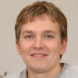 Joyful white adult male with short  brown hair and grey eyes