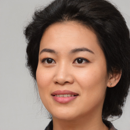 Joyful asian young-adult female with long  brown hair and brown eyes