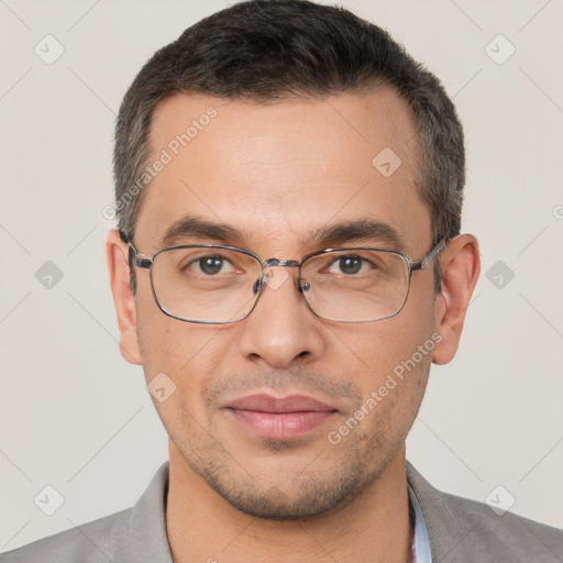 Joyful white adult male with short  brown hair and brown eyes