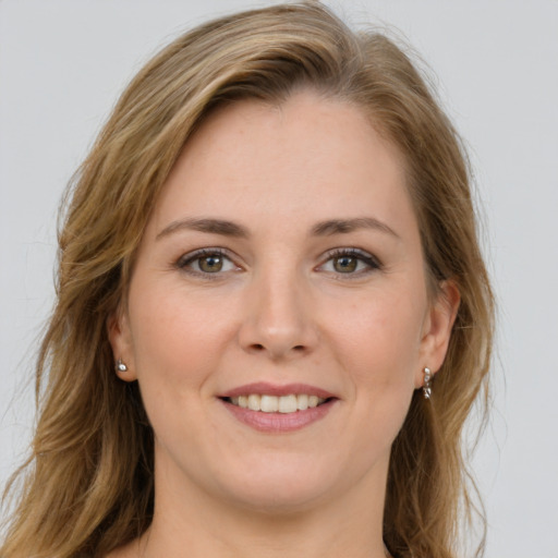 Joyful white young-adult female with long  brown hair and green eyes