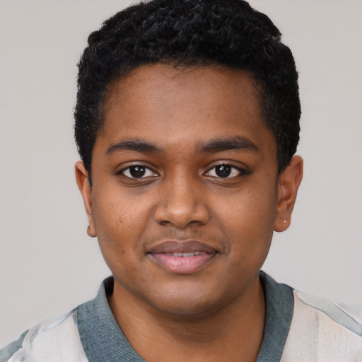 Joyful black young-adult male with short  black hair and brown eyes