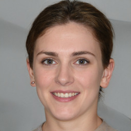 Joyful white young-adult female with short  brown hair and grey eyes