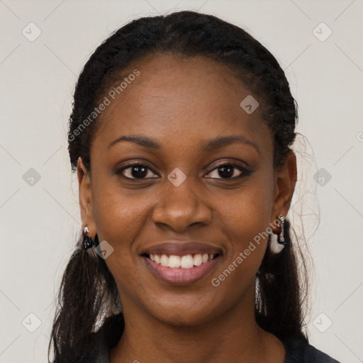 Joyful black young-adult female with long  black hair and brown eyes