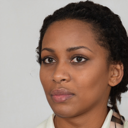 Neutral black young-adult female with medium  brown hair and brown eyes