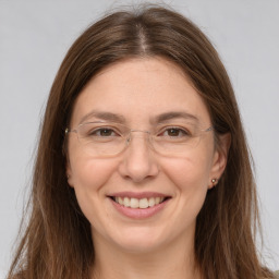 Joyful white young-adult female with long  brown hair and grey eyes