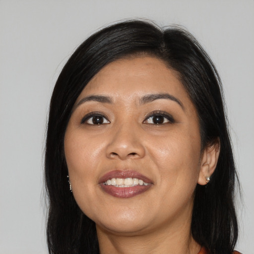 Joyful asian young-adult female with long  black hair and brown eyes