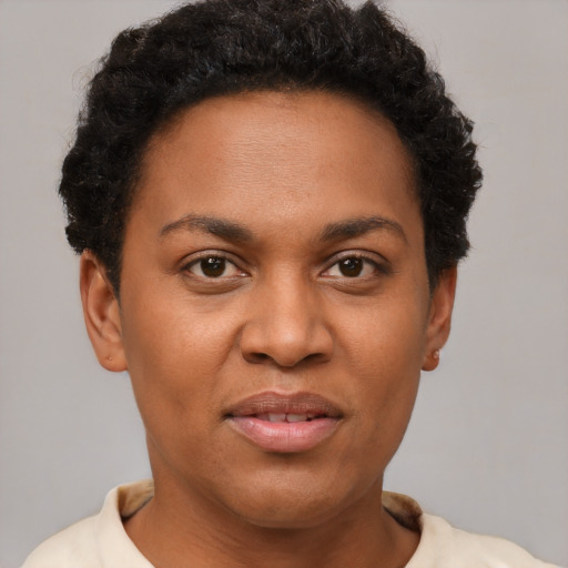 Joyful black young-adult female with short  brown hair and brown eyes