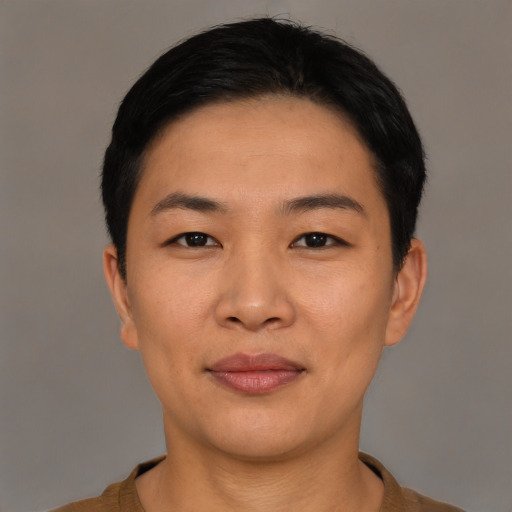 Joyful asian young-adult female with short  black hair and brown eyes