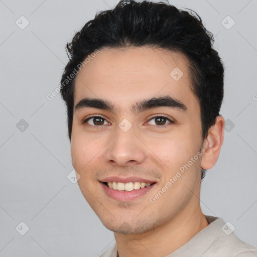 Joyful white young-adult male with short  black hair and brown eyes