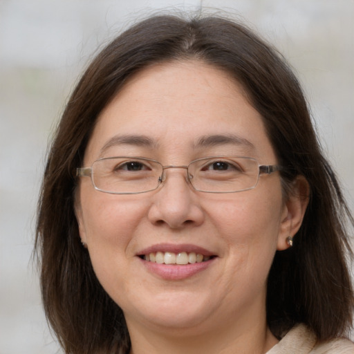 Joyful white adult female with medium  brown hair and brown eyes