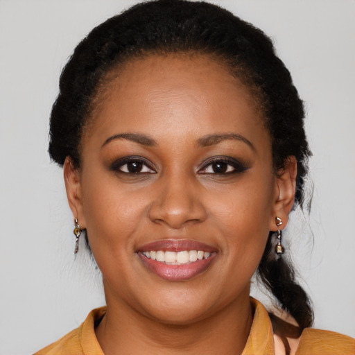 Joyful black young-adult female with medium  brown hair and brown eyes