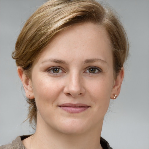 Joyful white young-adult female with medium  brown hair and grey eyes