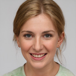 Joyful white young-adult female with medium  brown hair and blue eyes