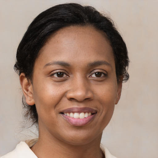 Joyful black young-adult female with medium  brown hair and brown eyes