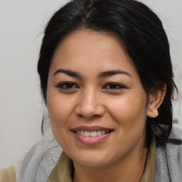 Joyful asian young-adult female with long  brown hair and brown eyes