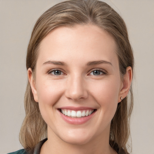 Joyful white young-adult female with medium  brown hair and grey eyes