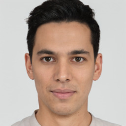 Joyful latino young-adult male with short  black hair and brown eyes