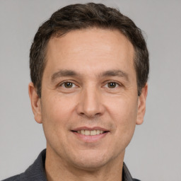 Joyful white adult male with short  brown hair and brown eyes