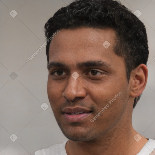 Joyful white young-adult male with short  black hair and brown eyes