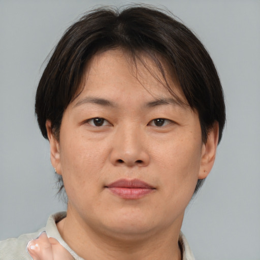 Neutral asian adult female with short  brown hair and brown eyes