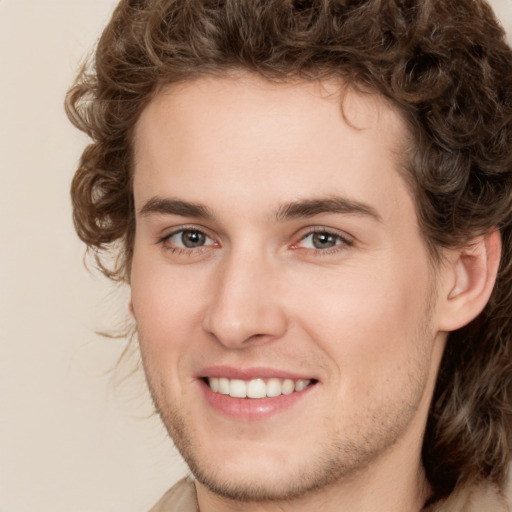 Joyful white young-adult male with medium  brown hair and brown eyes