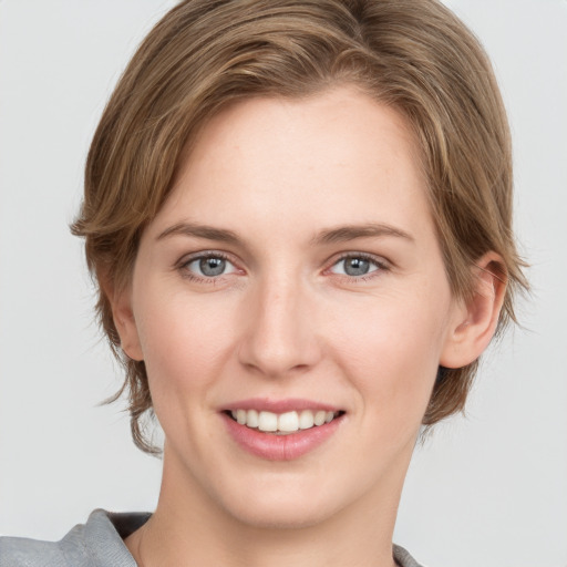 Joyful white young-adult female with medium  brown hair and grey eyes