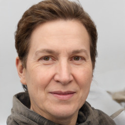 Joyful white adult female with medium  brown hair and grey eyes