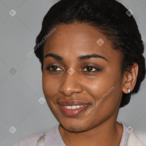 Joyful black young-adult female with short  black hair and brown eyes