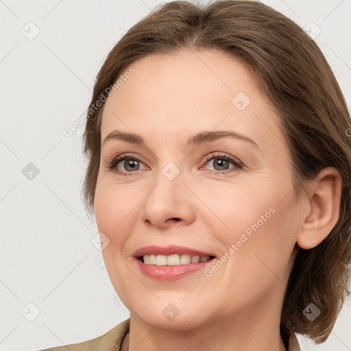 Joyful white adult female with medium  brown hair and grey eyes