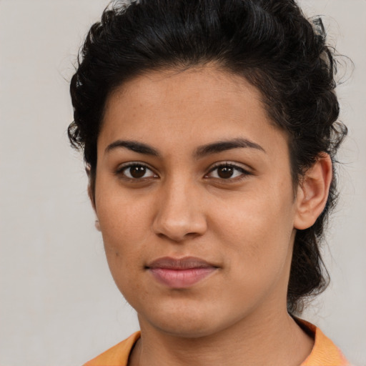 Joyful latino young-adult female with short  brown hair and brown eyes