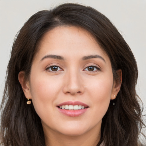 Joyful white young-adult female with long  brown hair and brown eyes