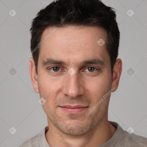 Joyful white adult male with short  black hair and brown eyes